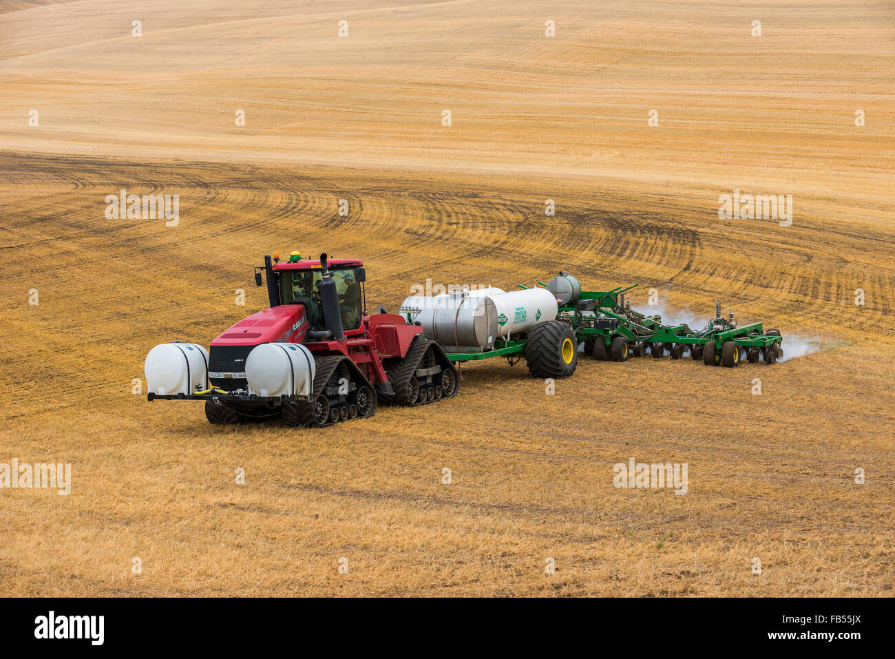 Case quadtrac tractor pulling an anhydrous ammonia tank and applicator