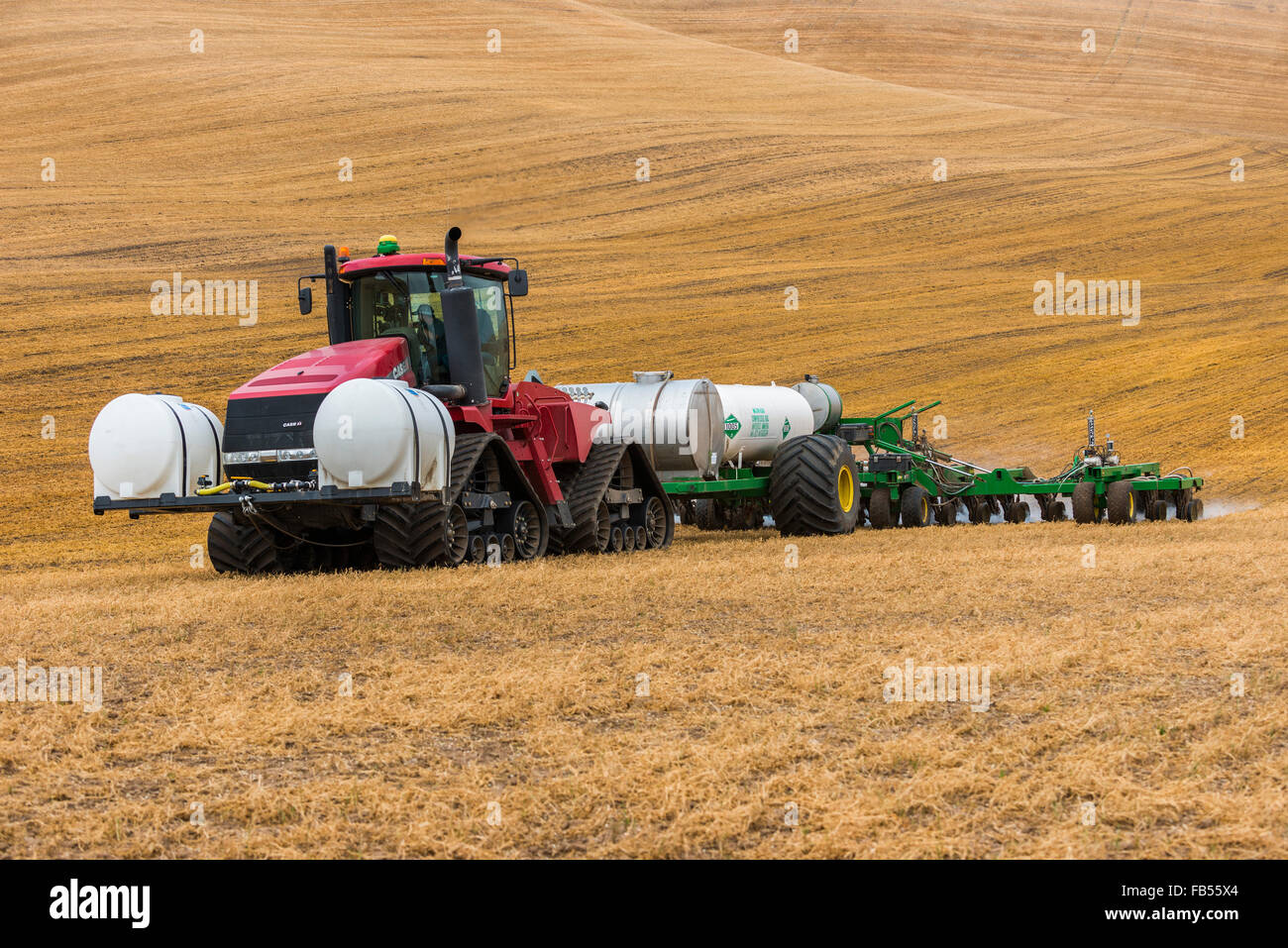 Case quadtrac tractor pulling an anhydrous ammonia tank and applicator