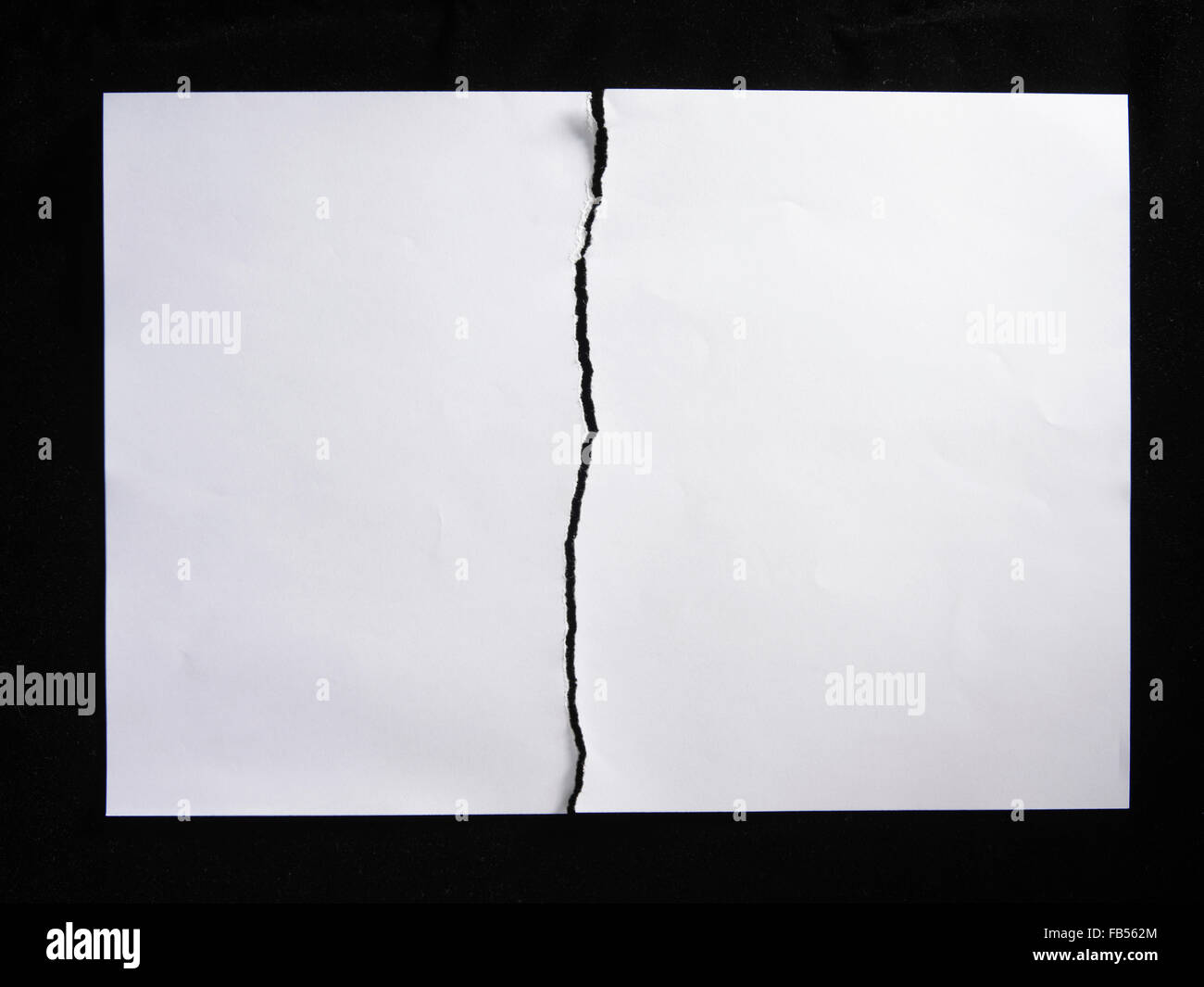 torn or tearing paper into two pieces Stock Photo Alamy