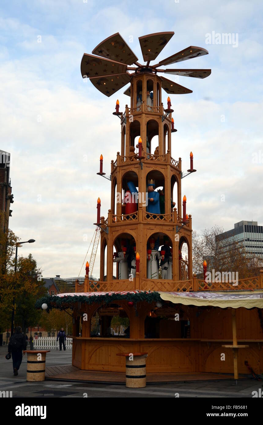 A stall at the Continental Christmas markets in Manchester with a rotating tower with puppets Stock Photo