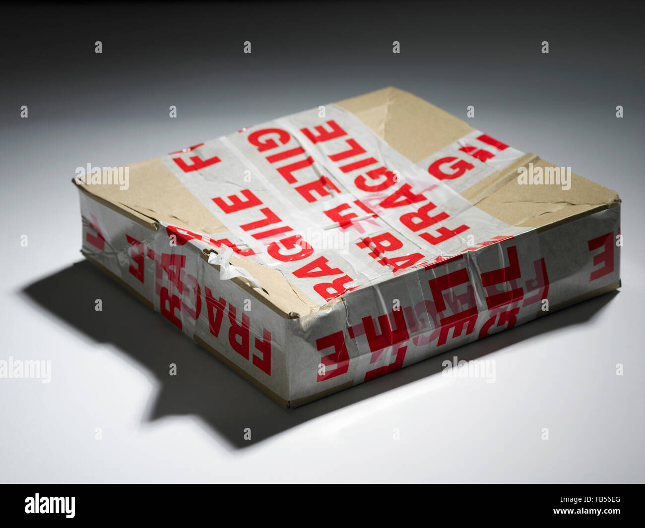 a damaged box with the fragile sticker on it Stock Photo
