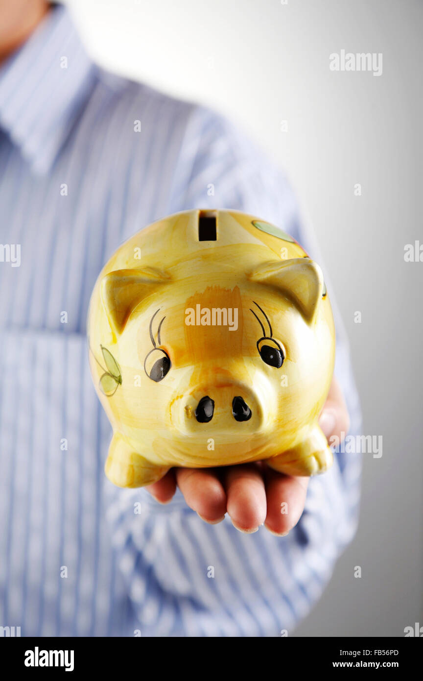 man showing a piggy bank Stock Photo - Alamy