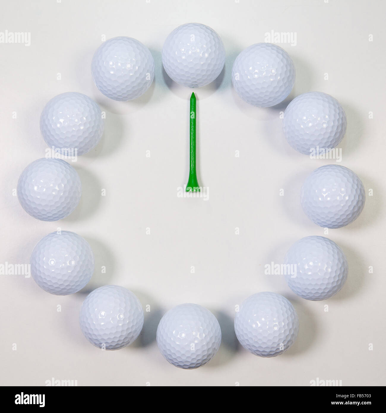 Golf Time The clock of golf balls and wooden tees Stock Photo Alamy