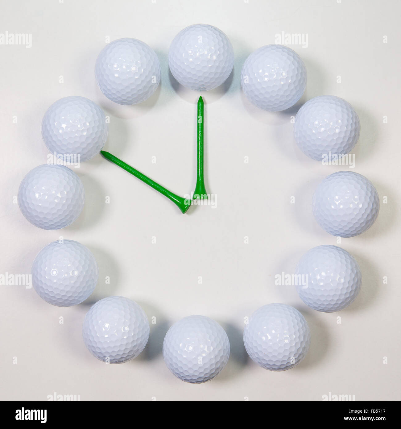 Golf Time The clock of golf balls and wooden tees Stock Photo Alamy