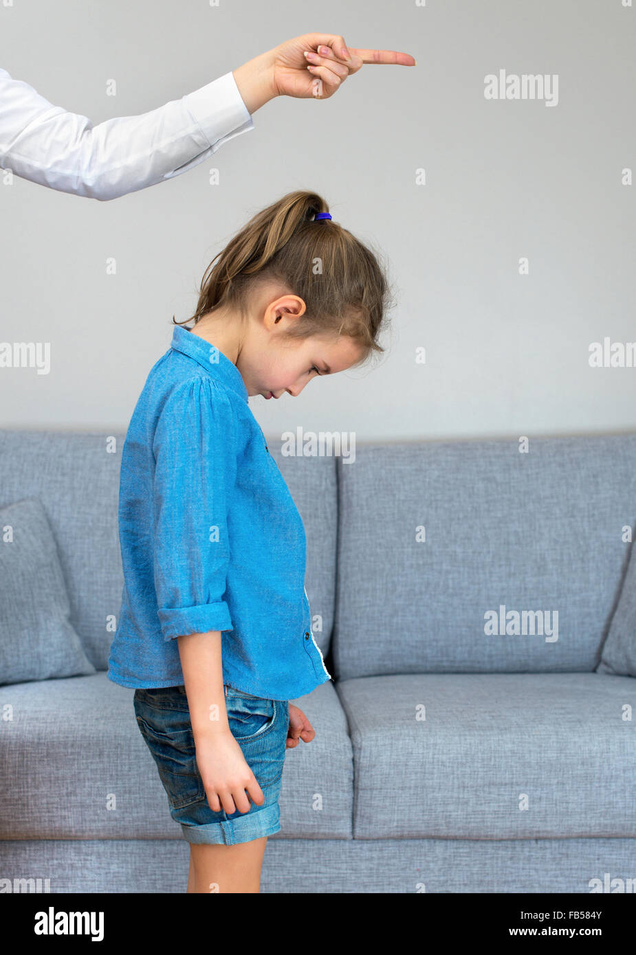 Mother scolds little girl at home. Stock Photo