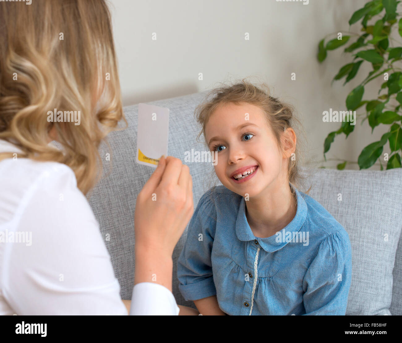 Mother and daughter playing board game at home Stock Photo Alamy