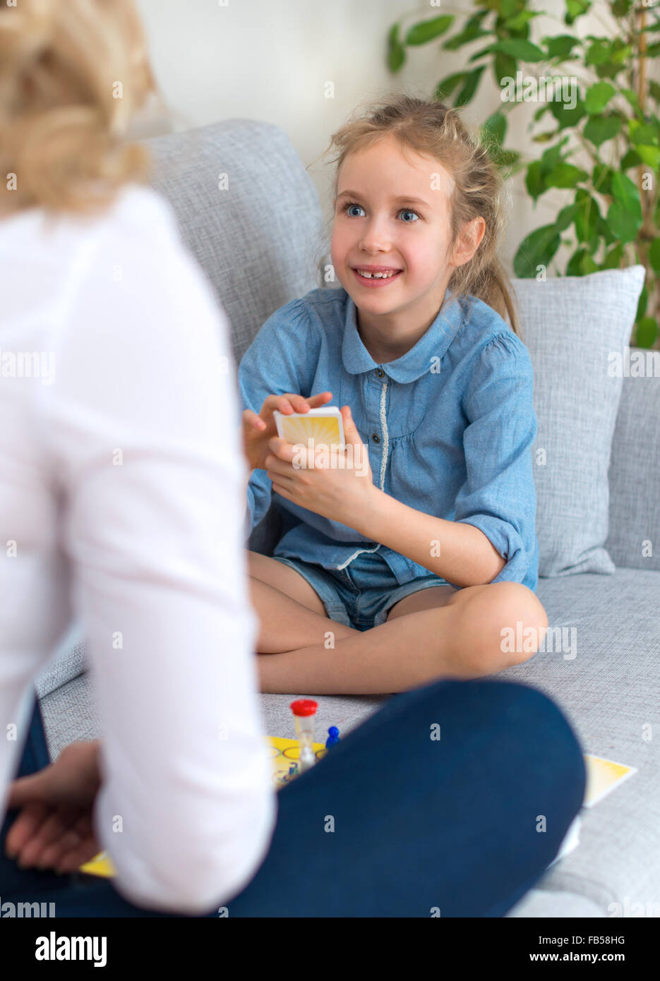 Mother and daughter playing board game at home Stock Photo Alamy