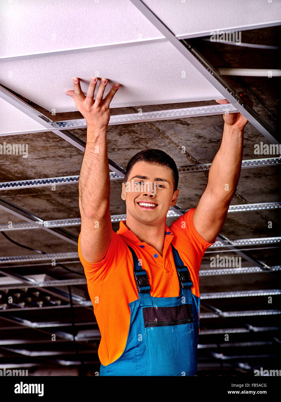 Man installing suspended ceiling Stock Photo - Alamy