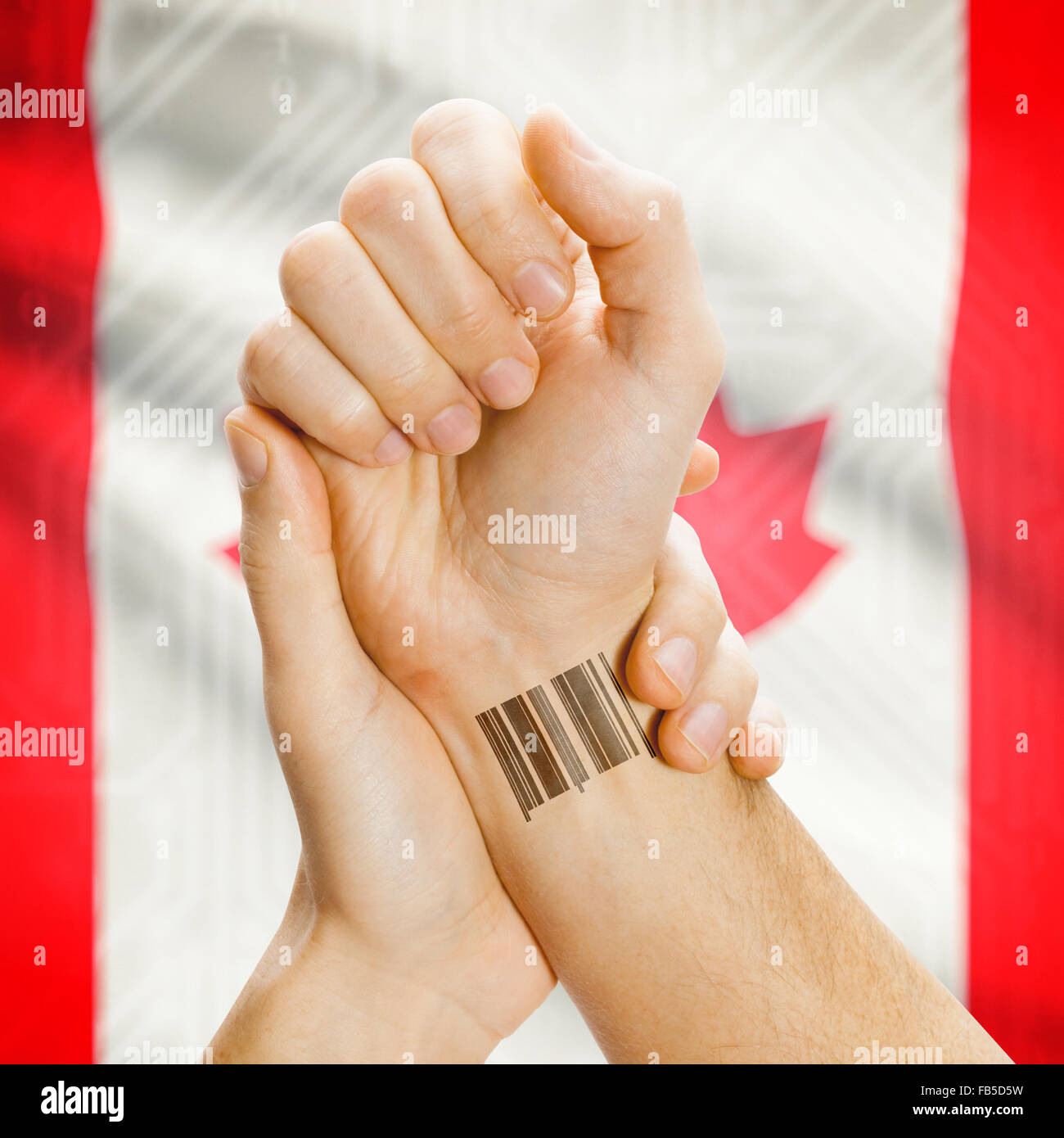 Barcode ID number on wrist of a human and national flag on background