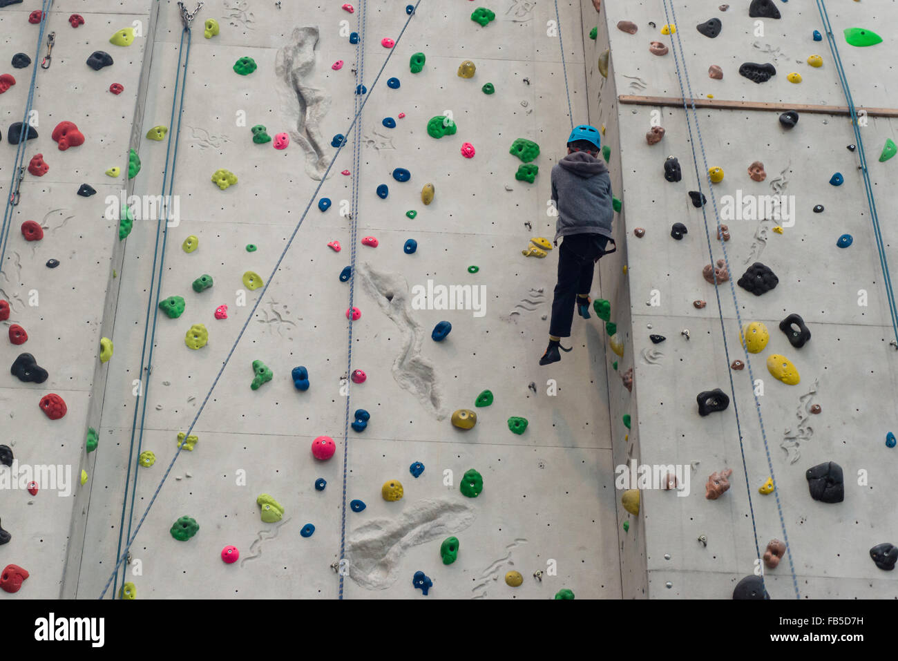 Boy traversing down Edinburgh International climbing Arena (EICA) near Ratho Stock Photo