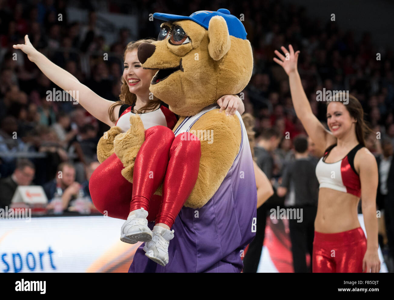 A mascot carries a member of the Brose Baskets Dance Team across the