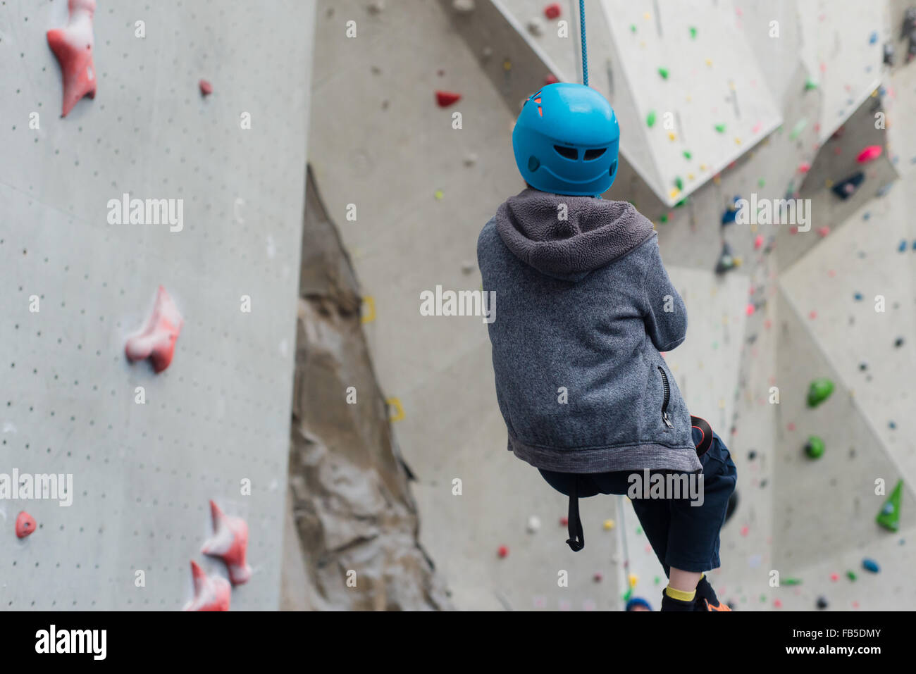 Boy swinging on ropes at Edinburgh International climbing Arena (EICA) near Ratho Stock Photo