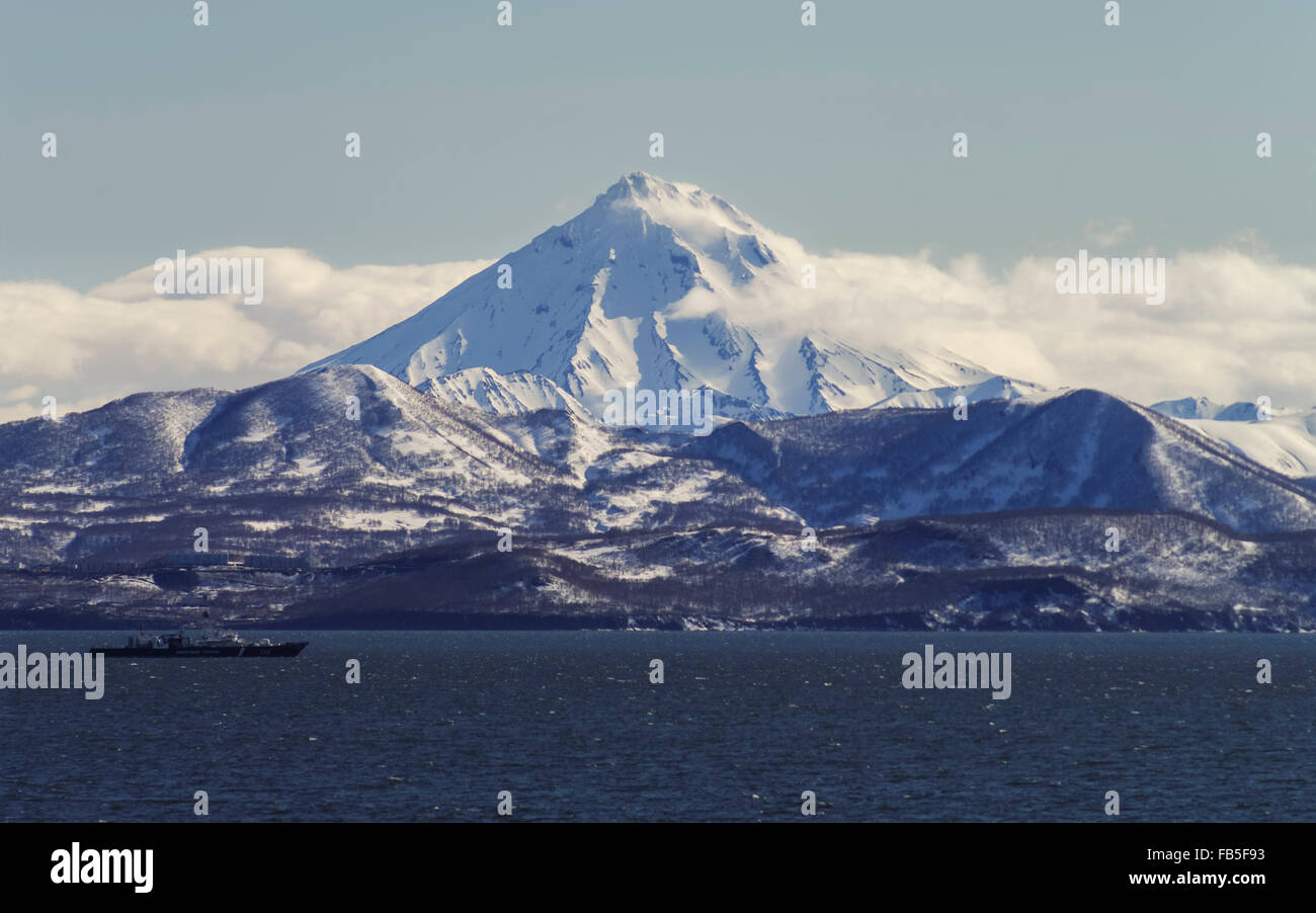 Snow-covered Vilyuchik volcano in Kamchatka, seen from Petropavlovsk-Kamchatskiy across Avacha bay. Stock Photo
