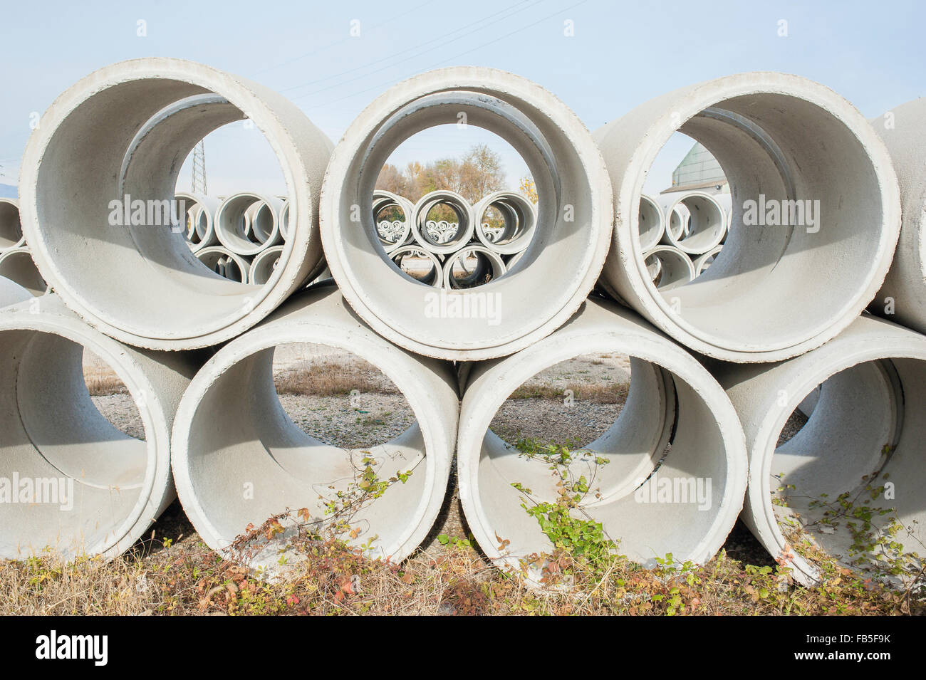 Concrete drainage pipes for industrial building construction. Stock Photo