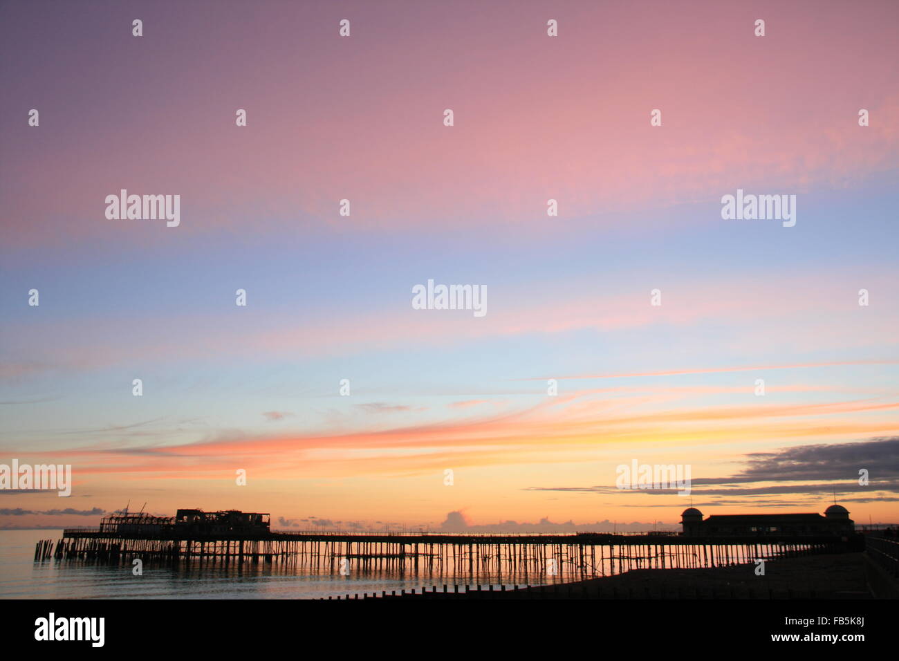 A SUNSET AT HASTINGS PIER IN THE UK BEFORE RESTORATION BEGAN Stock Photo