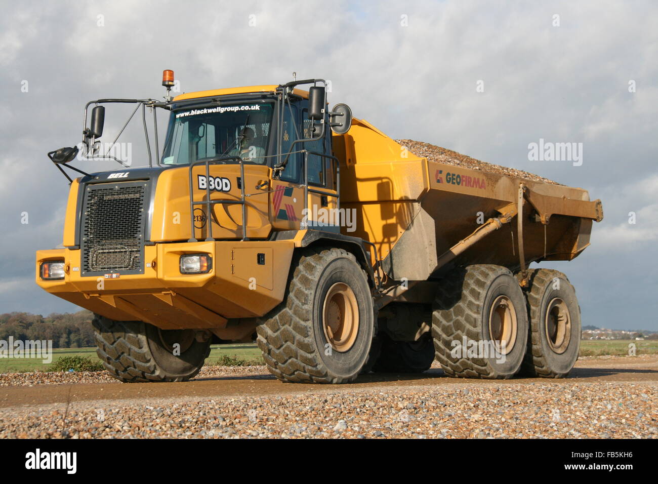 A monster truck working for the Environment Agency moving shingle as part of regular sea defence work at Pett Level. Stock Photo