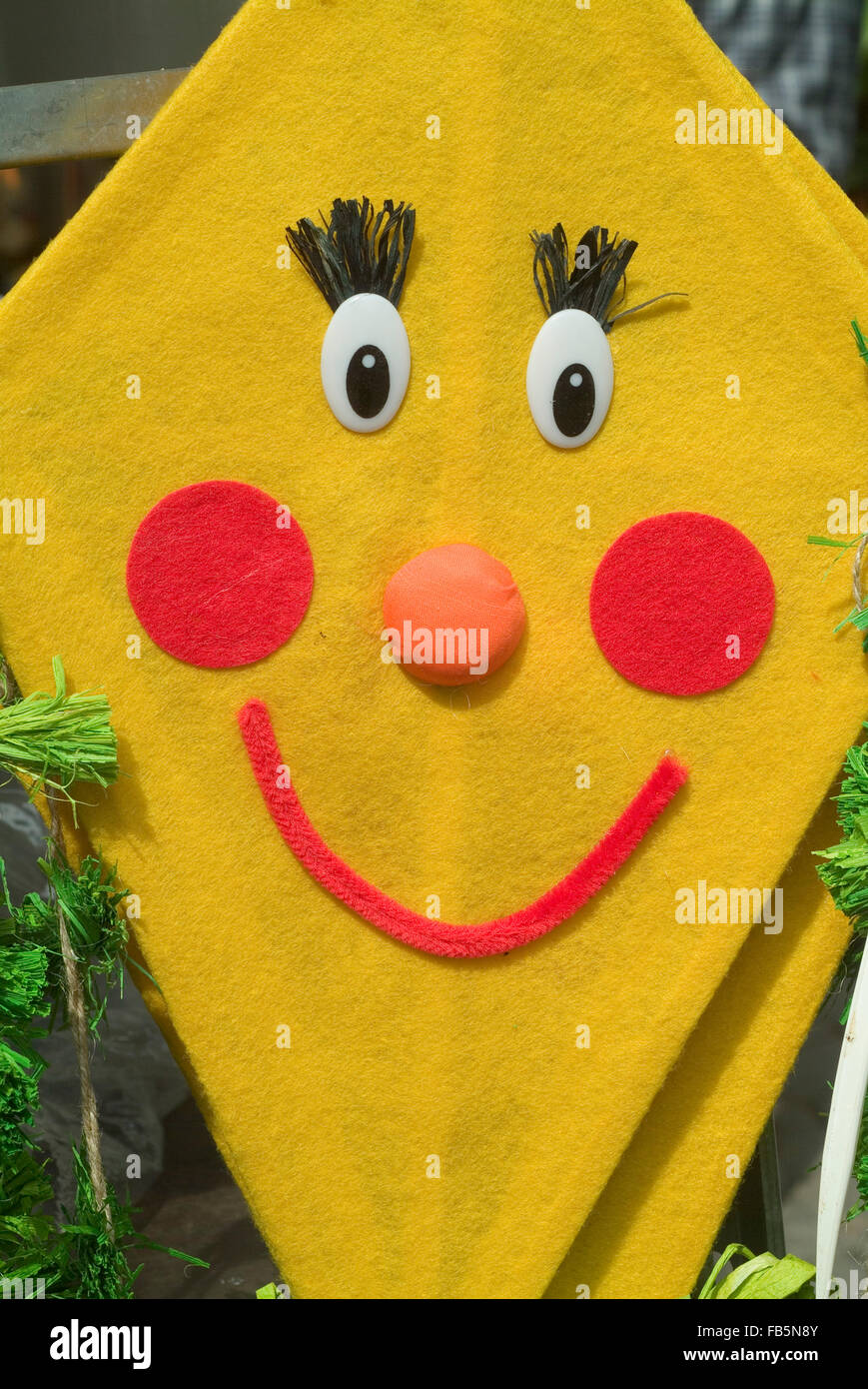 Colorful kite made of cloth with a funny face Stock Photo