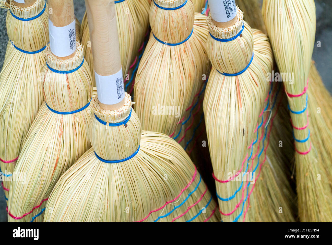 Brooms from nature materials on a market stall Stock Photo