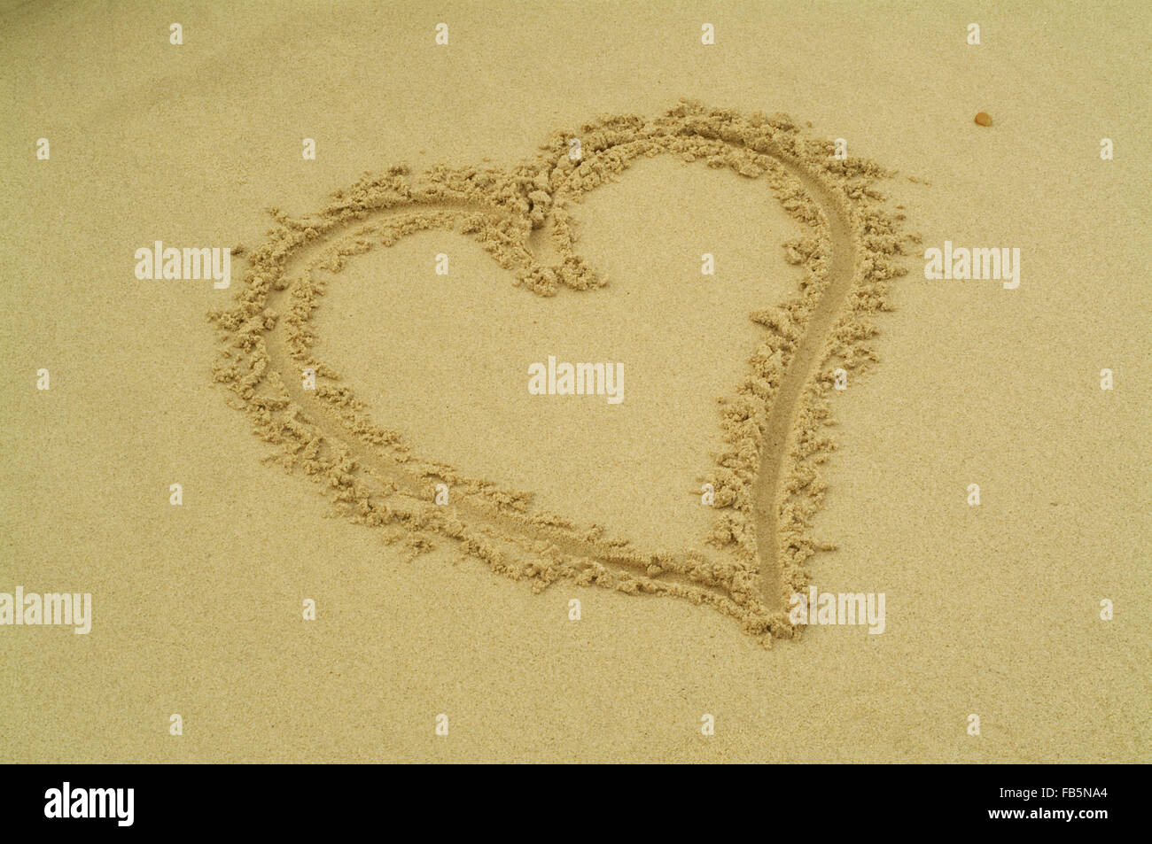 A heart painted in the sand beach Stock Photo