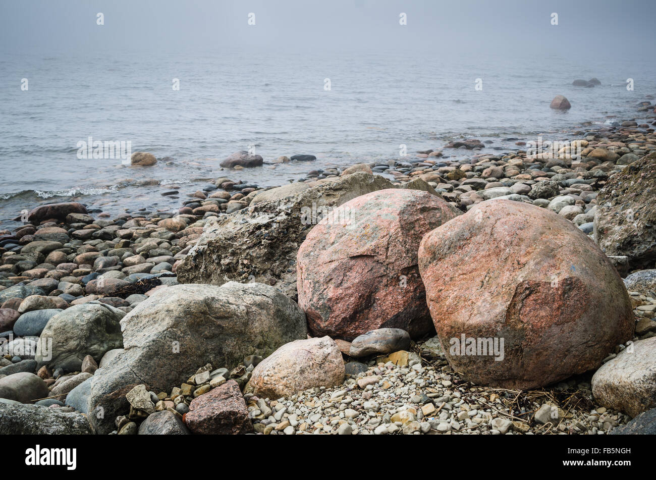 Stony coast of Baltic sea foggy in the morning Stock Photo