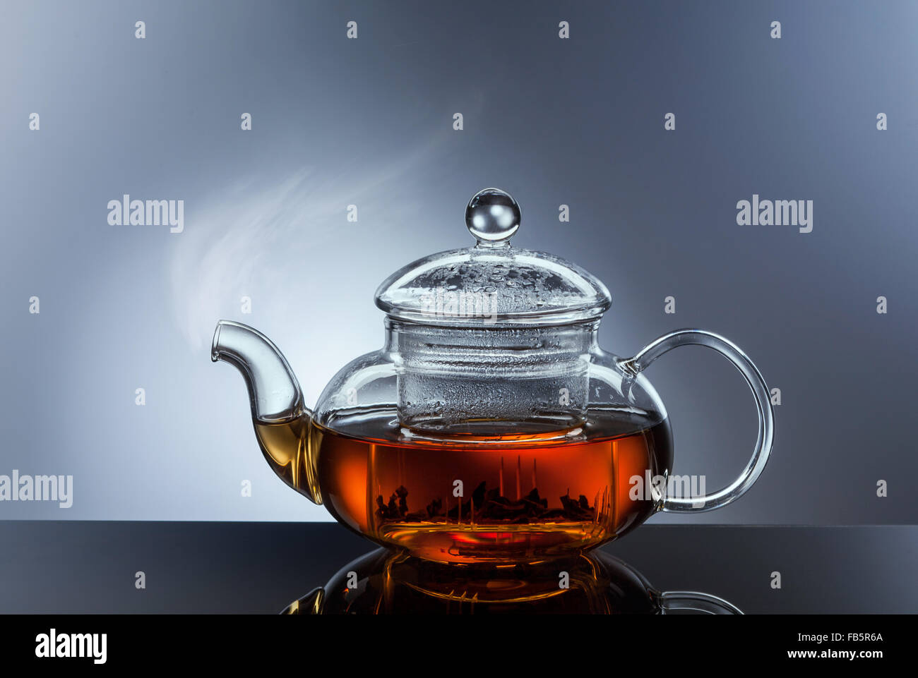 glass teapot cup with hot black tea and steam Stock Photo Alamy