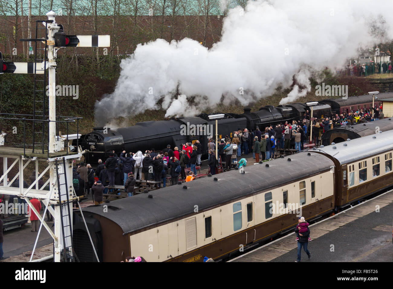 Bury, Lancashire. 10 January 2016. Flying Scotsman, the famous British steam locomotive built in 1923, newly out of the Riley and Son's Engineering works after its £4.2 million rebuild, continues its trial runs on the East Lancashire Railway at Bury, watched by hundreds of train enthusiasts. The engine, still in its wartime black livery, has further trial runs in Bury next week prior to a high speed run on the west coast main line. Credit:  Joseph Clemson 1/Alamy Live News Stock Photo