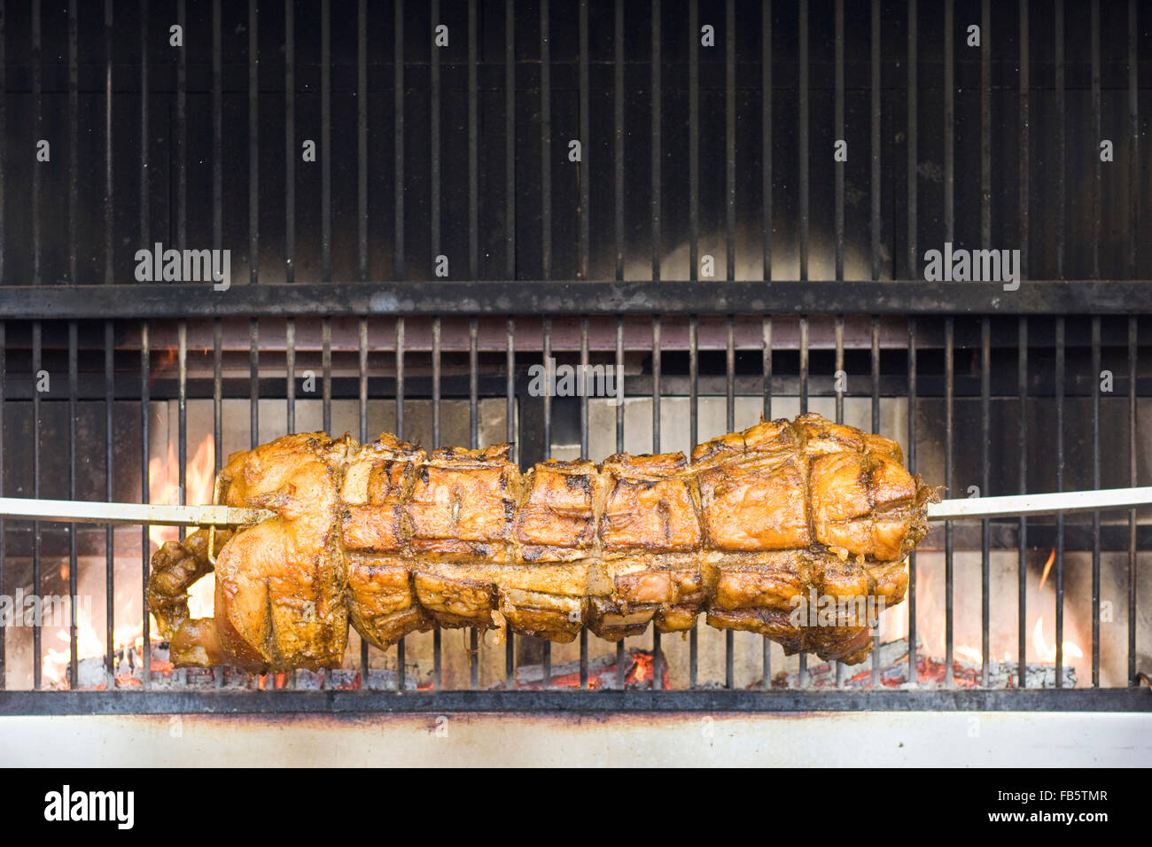 Pig roasting of an open fire pit Stock Photo