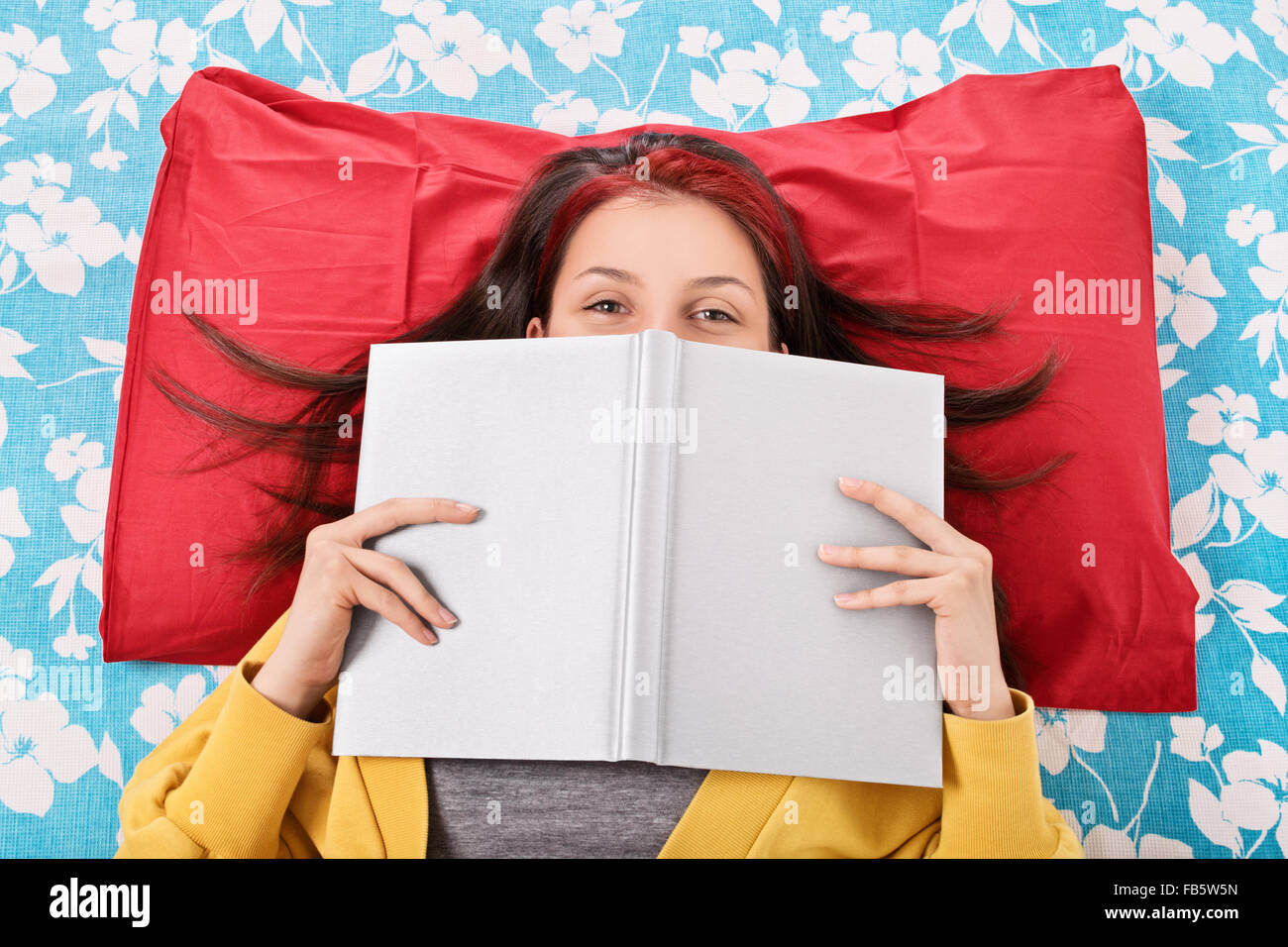 How this read makes me laugh. Young girl lying in bed, hiding her smile