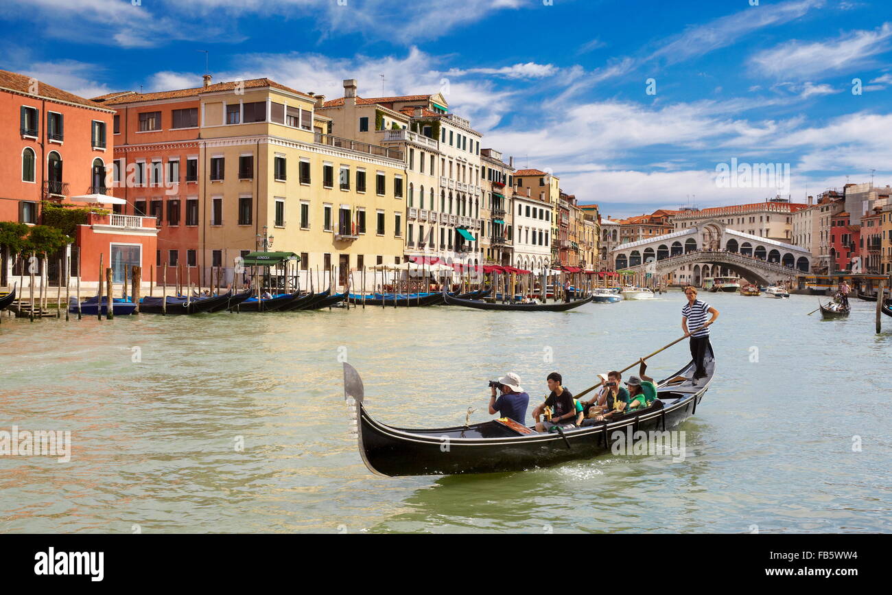 Gondola with tourists on Grand Canal, Venice cityscape, Italy, UNESCO Stock Photo