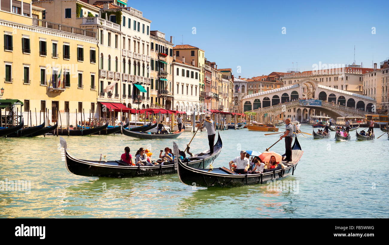 Gondola with tourists on Grand Canal, Venice cityscape, Veneto, Italy, UNESCO Stock Photo