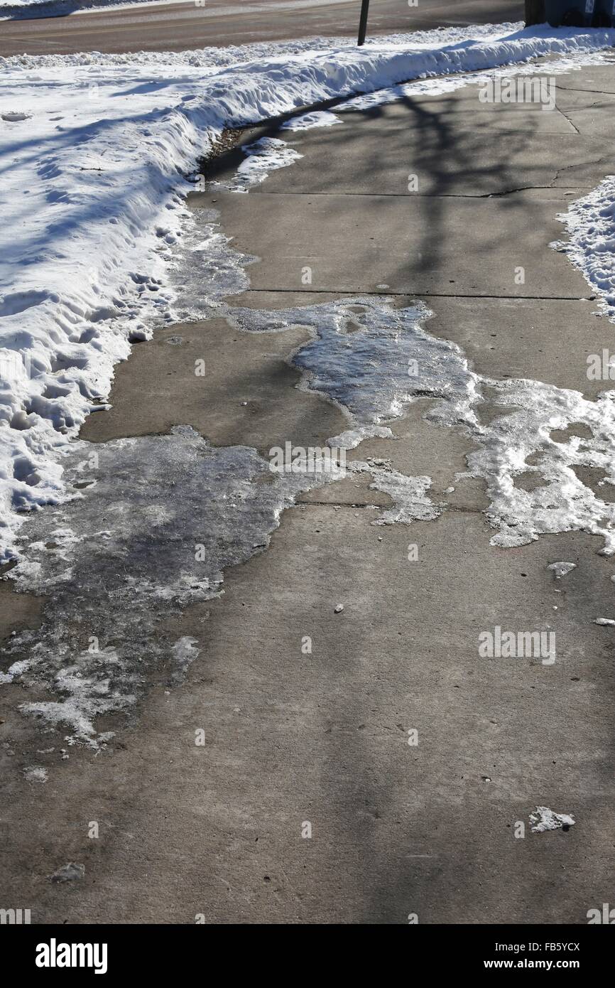 Icy patches on a sidewalk Stock Photo Alamy