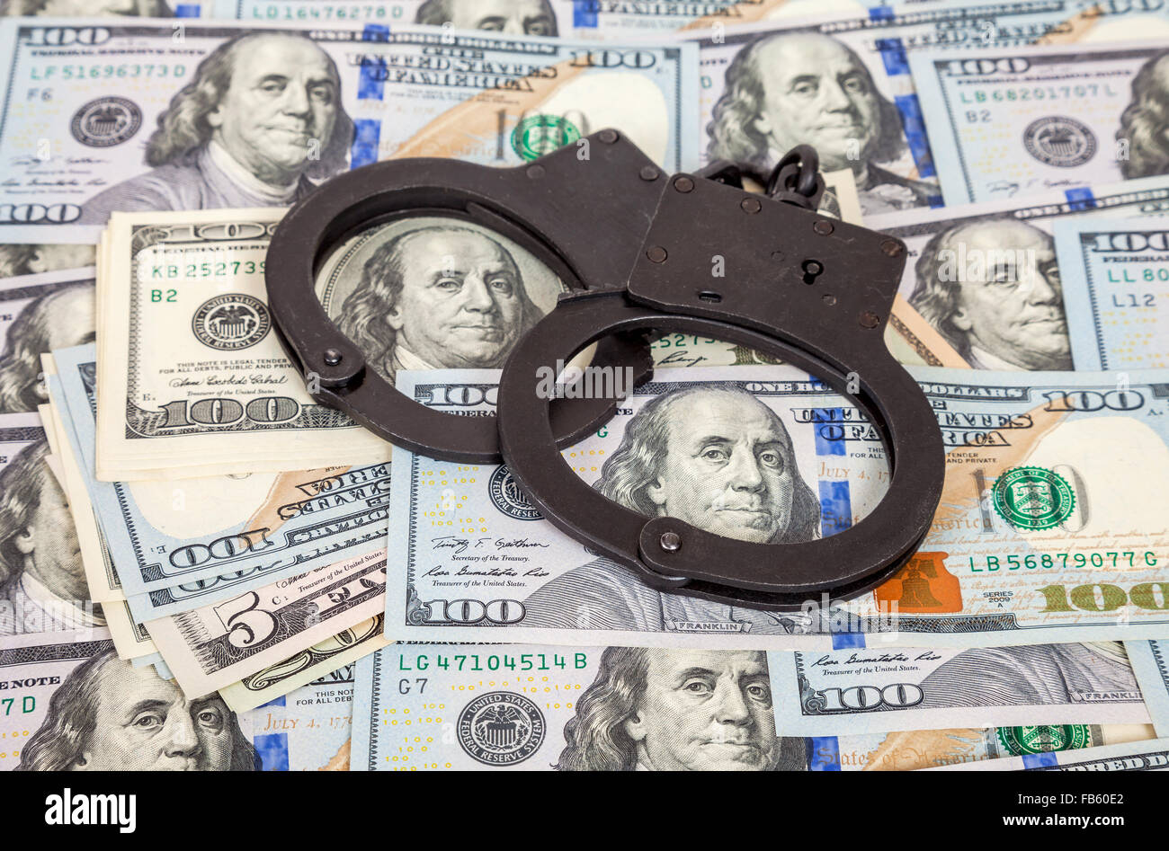 Steel handcuffs lying on the american dollar bills Stock Photo Alamy
