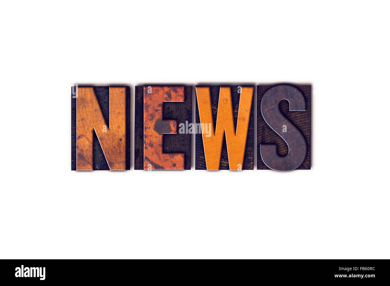 The word "News" written in isolated vintage wooden letterpress type on a white background. Stock Photo