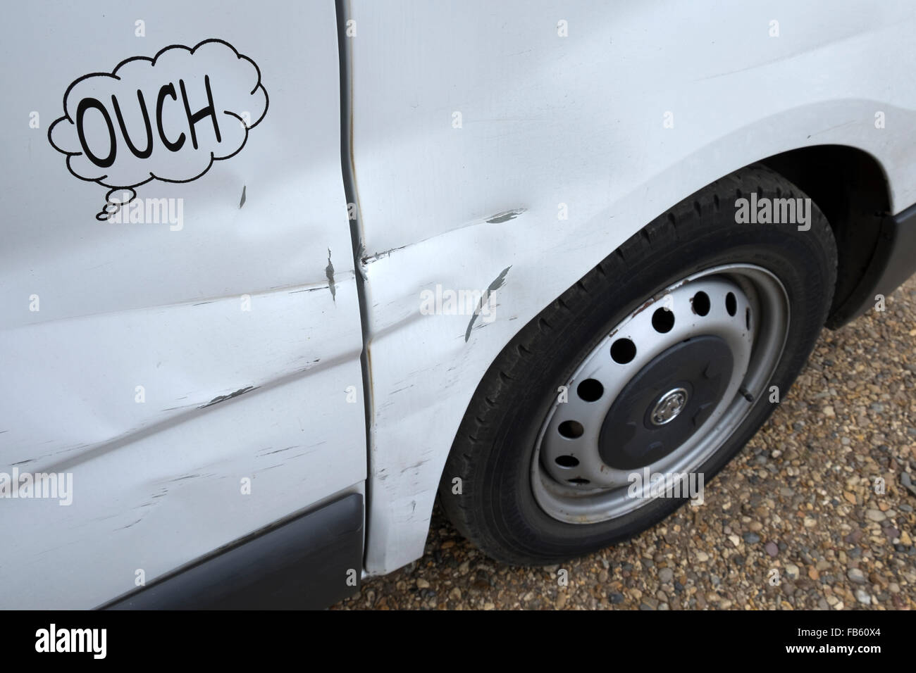 Vauxhall van with dented side panel and the word Ouch in speech bubble Stock Photo