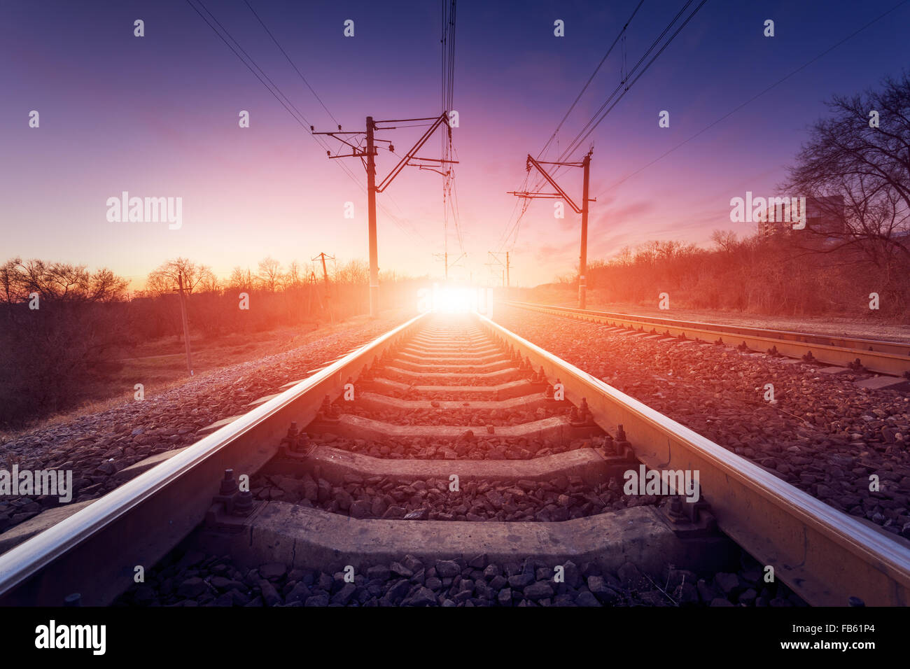 Train platform at sunset. Railroad in Ukraine. Railway landscape. Stock Photo