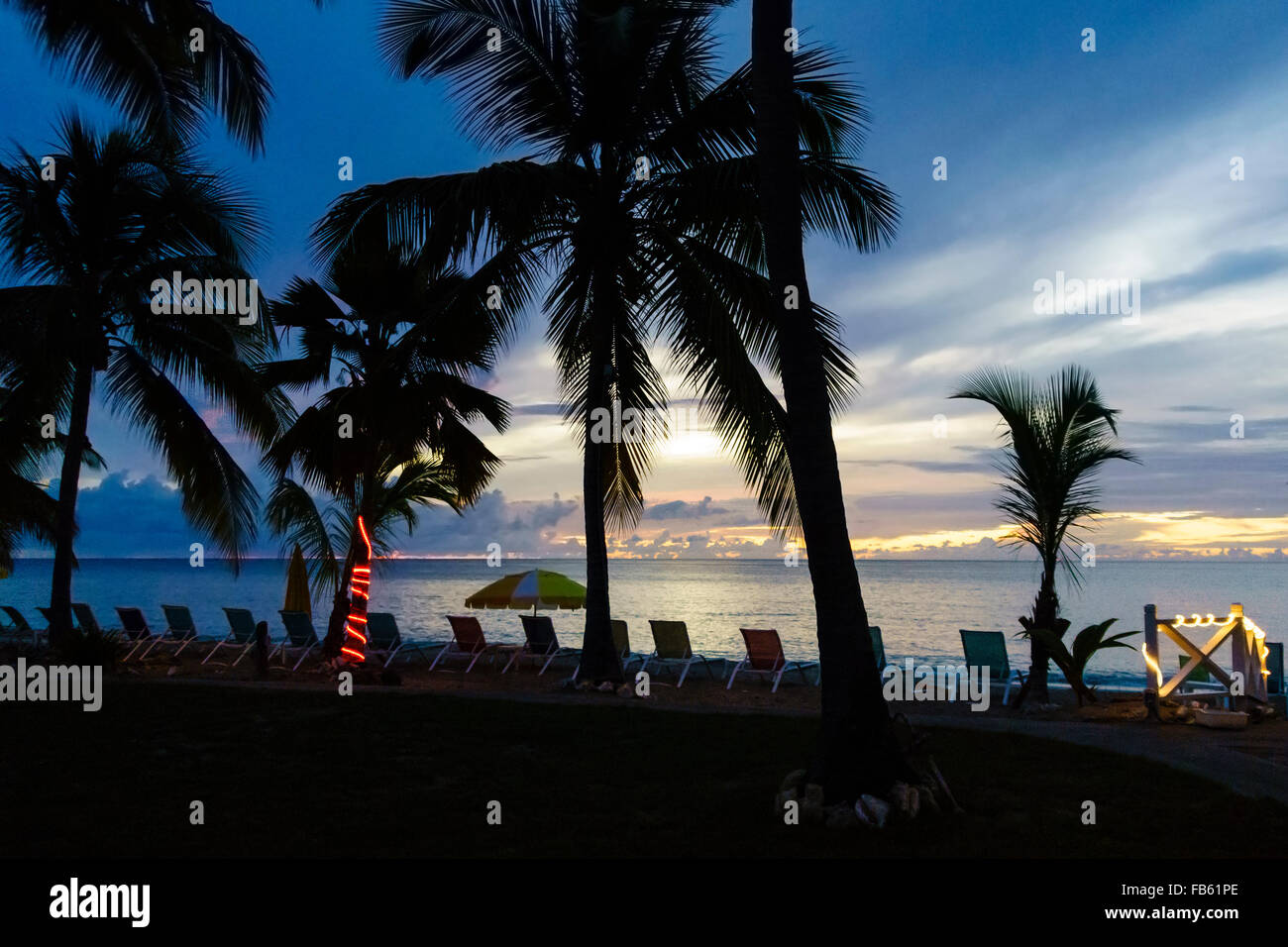 The sun sets over the Caribbean sea at a beachside resort on St. Croix, U.S. Virgin Islands. Stock Photo
