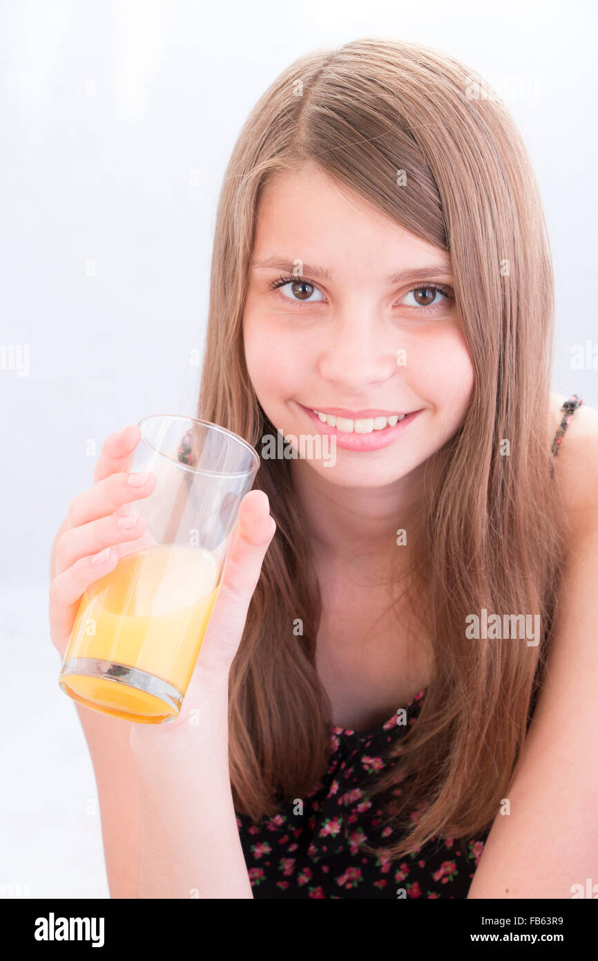 Teenage girls drinking orange juice Stock Photo Alamy