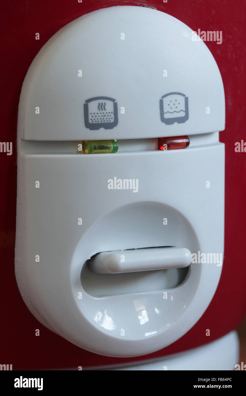 Pareidolia: The on switch on a rice cooker looks like a face Stock Photo