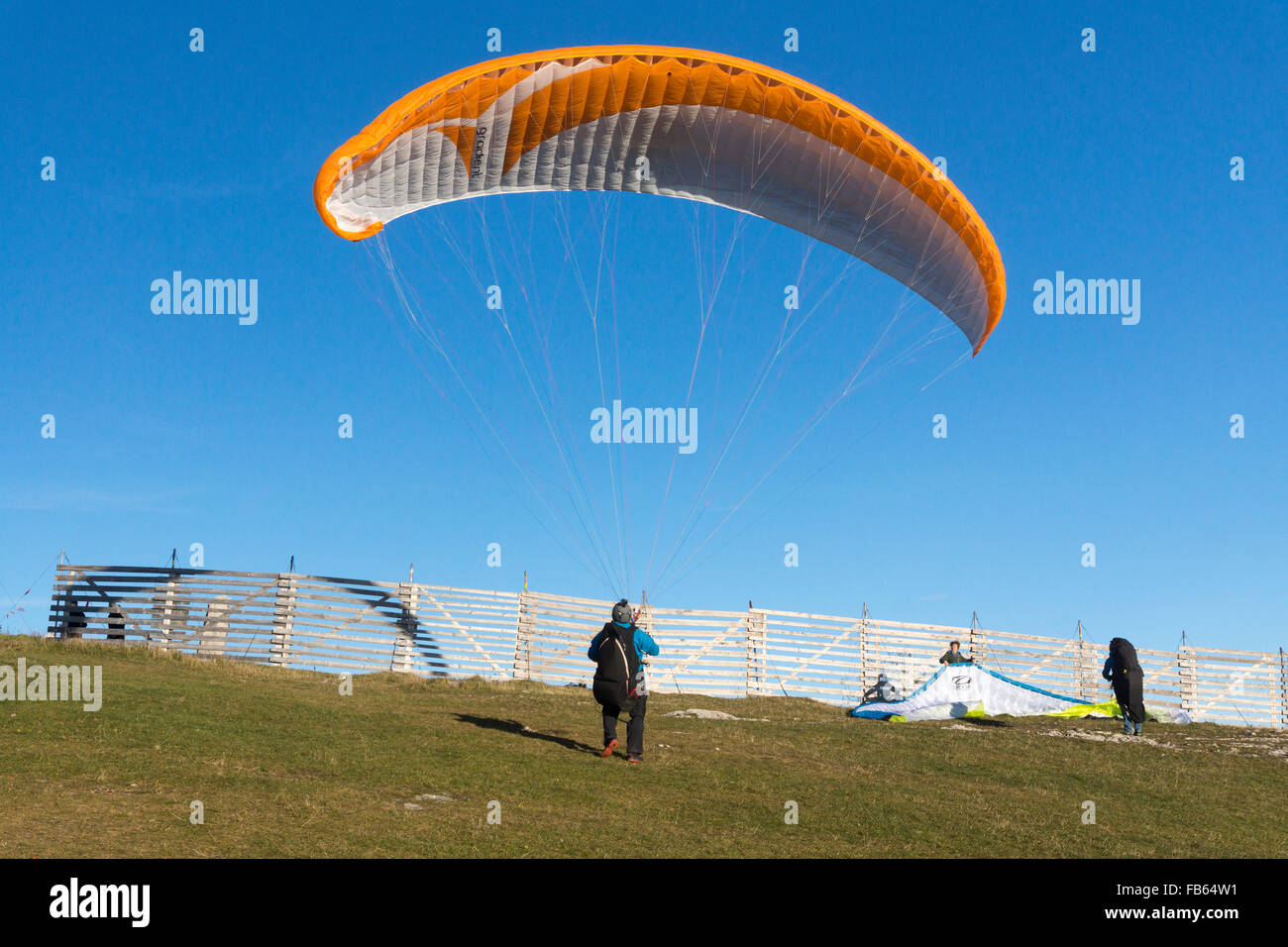 A paraglider preparing for a reverse launch off Gaisberg mountain in ...
