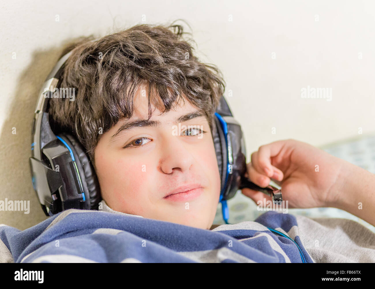 boy with wearing headphones while playing with video games Stock Photo ...