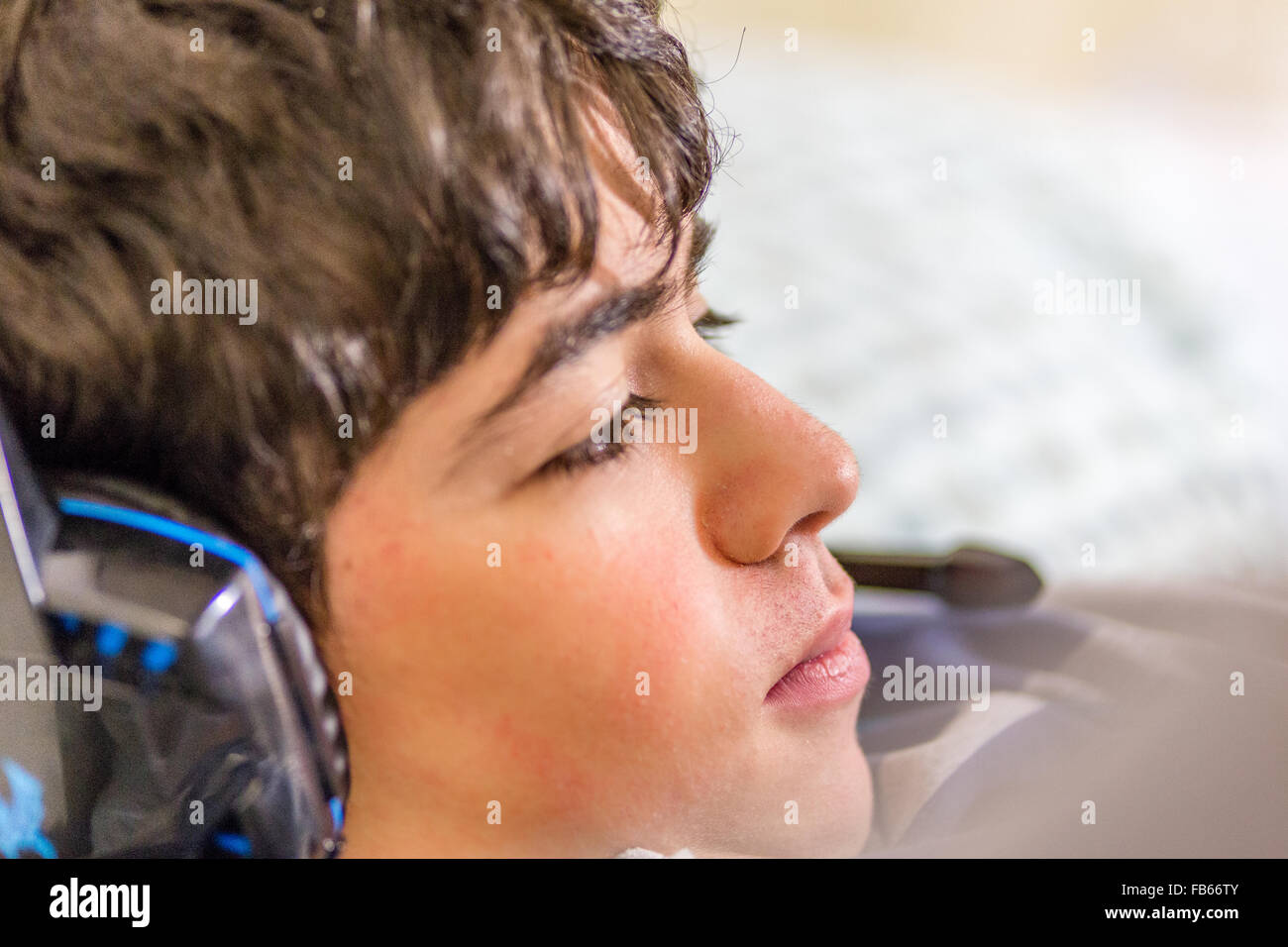 boy with wearing headphones while playing with video games Stock Photo ...