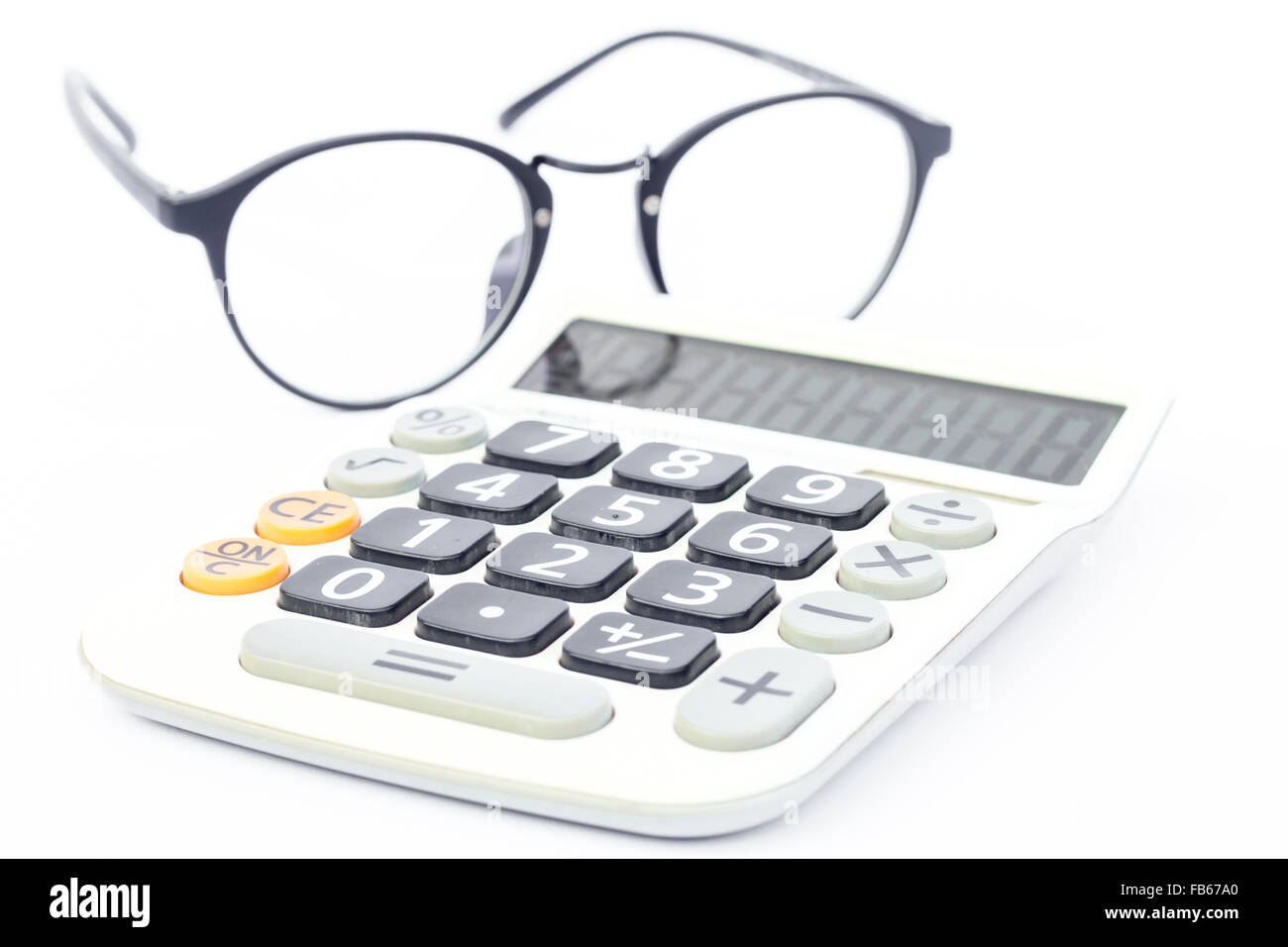 Calculator with eyeglasses isolated on white background, stock photo Stock Photo Alamy