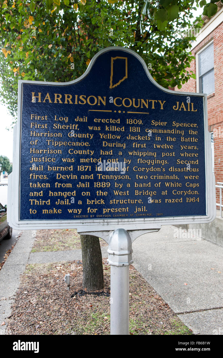 HARRISON COUNTY JAIL  First Log Jail erected 1809. Spier Spencer, First Sheriff, was killed 1811 commanding the Harrison County Yellow Jackets in the Battle of Tippecanoe. During first twelve years, Harrison County had a whipping post where justice was meted out by floggings. Second Jail burned 1871 in one of Corydon's disastrous fires. Devin and Tennyson, two criminals, were taken from Jail 1889 by a band of White Caps and hanged on the West Bridge at Corydon. Third Jail, a brick structure, was razed 1964 to make way for present jail.  Erected by Corydon Chamber of Commerce, 1965 Stock Photo