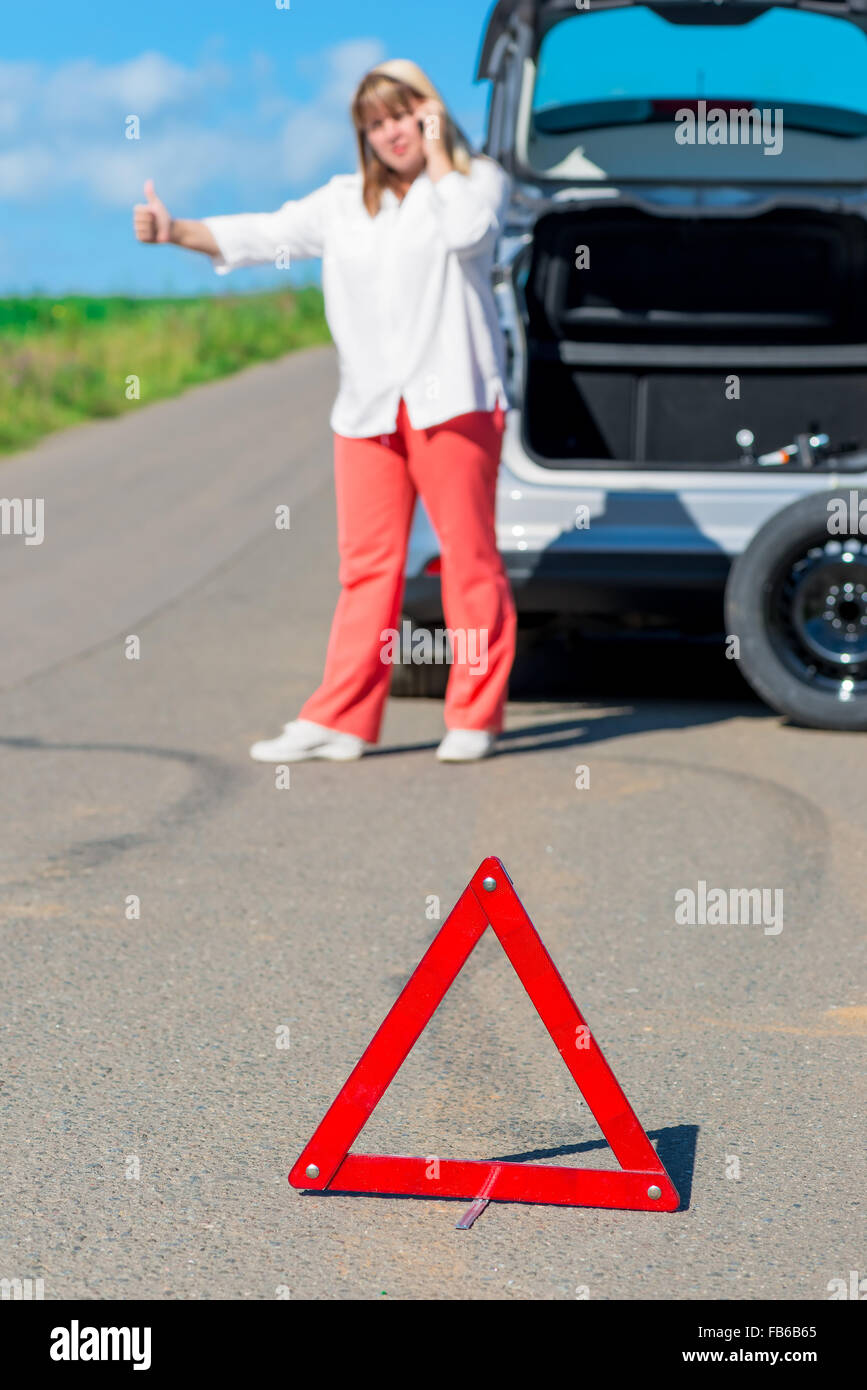 female driver on the road asking for help on the phone Stock Photo