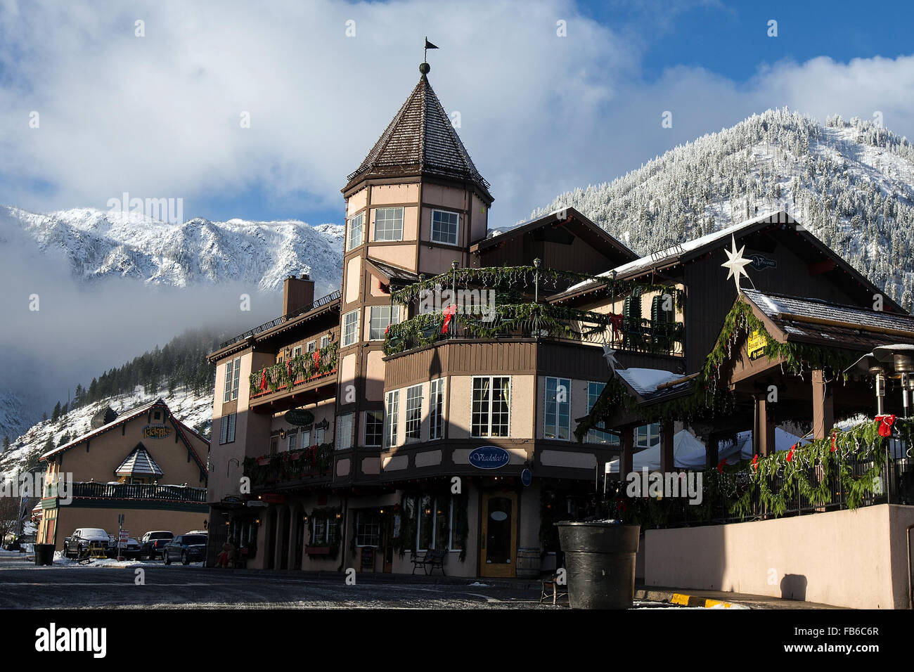 Bavarian building with snow covered mountains, Leavenworth, Washington, United States of America Stock Photo