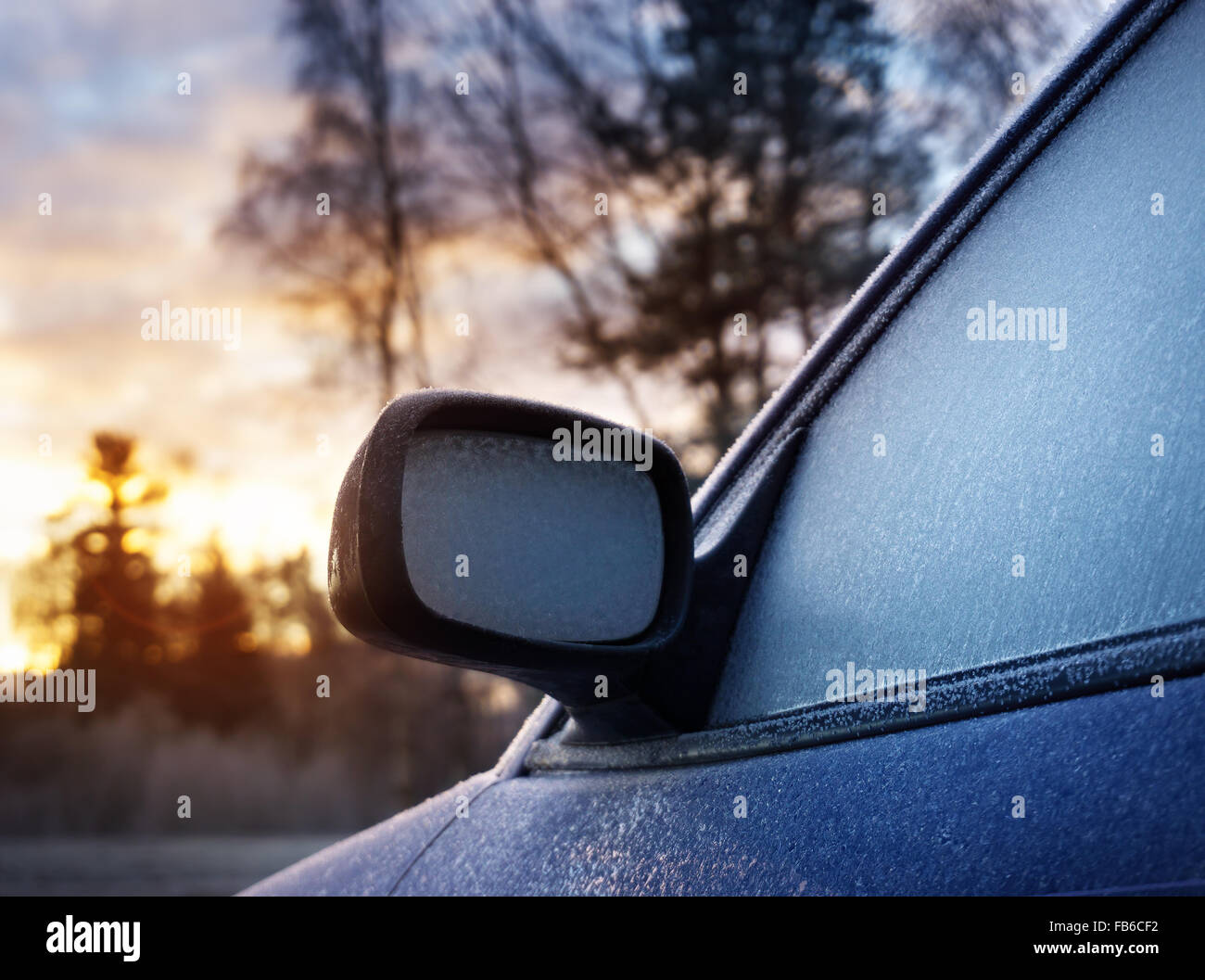 Car window and side mirror covered with ice in the morning Stock Photo
