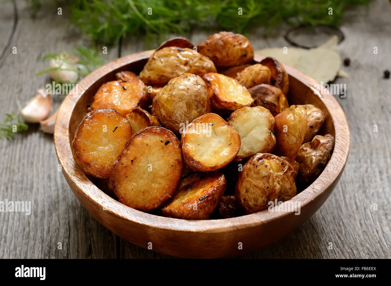 Roasted potato in wooden bowl Stock Photo