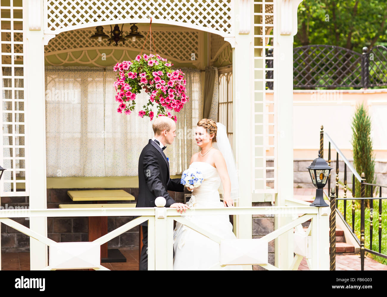 bride and groom in the gazebo Stock Photo - Alamy