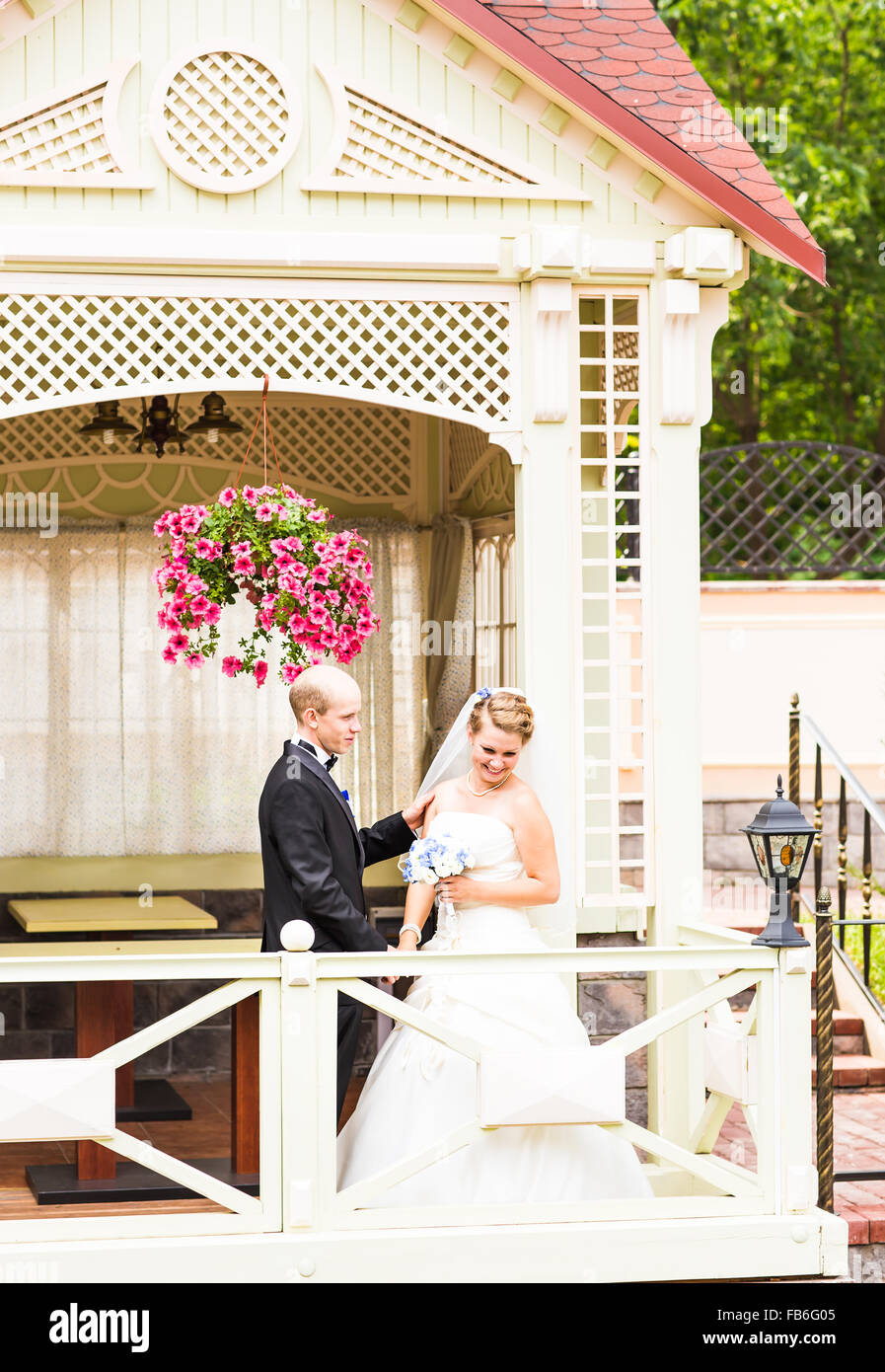 bride and groom in the gazebo Stock Photo - Alamy