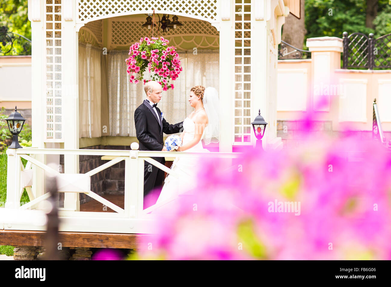 bride and groom in the gazebo Stock Photo - Alamy